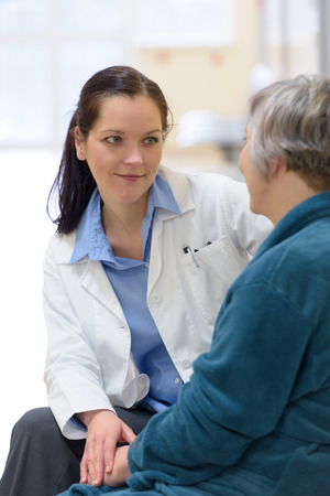 Female doctor comforting senior patientの写真素材