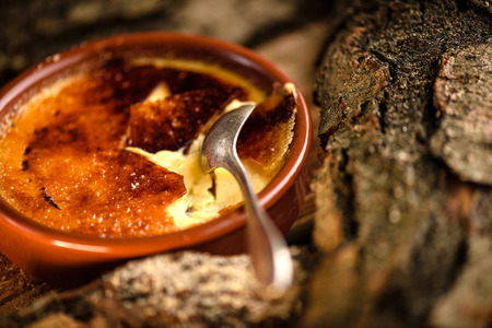 French creme brulee cracked caramel sugar topping by spoonの写真素材