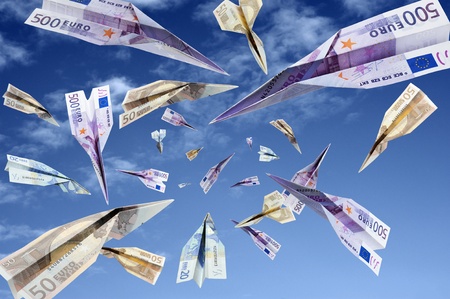 euro banknotes flying on blue skyの写真素材