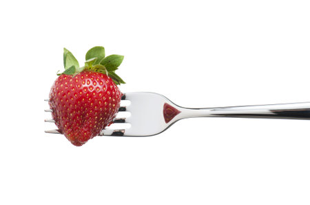 strawberry stuck in the fork, isolated on whiteの写真素材
