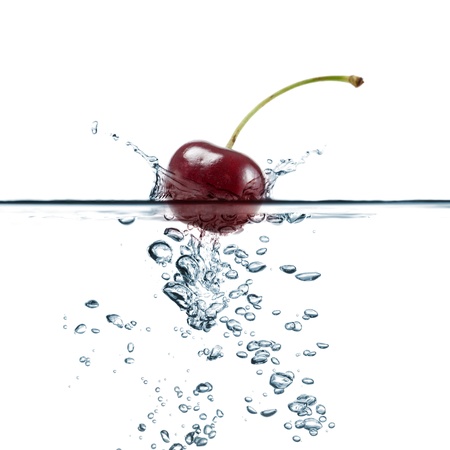 cherry splash in transparent water, on white backgroundの写真素材