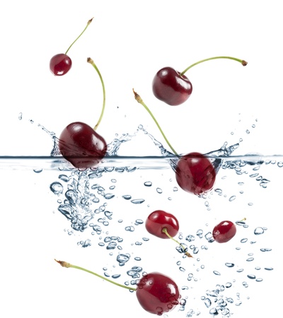cherries splash in transparent water, on white backgroundの写真素材