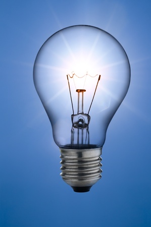 incandescent light bulb, on sunny skies backgroundの写真素材