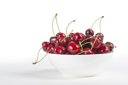 cup with cherries, on white backgroundの写真素材