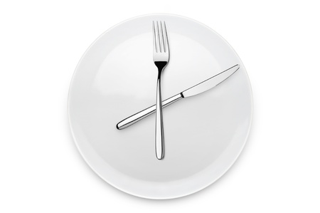 plate with fork and knife at twelve o'clock position, on white backgroundの写真素材