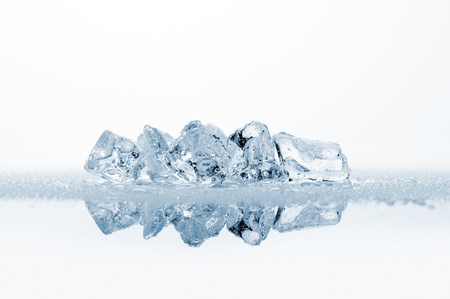 ice cubes with water drops, on white background with reflectionsの写真素材