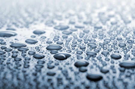 water drops on blue surface, focus in the middle, shallow depth of fieldの写真素材
