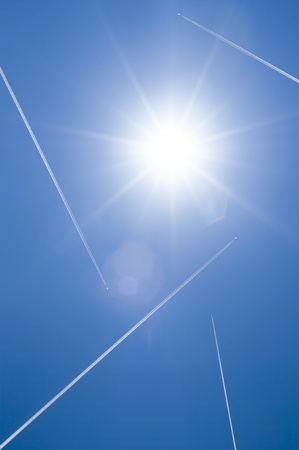 airplanes flying on blue sky with sunの写真素材