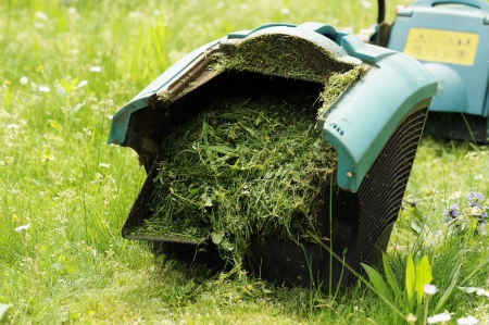 binder lawn mower full of lawn grassの写真素材