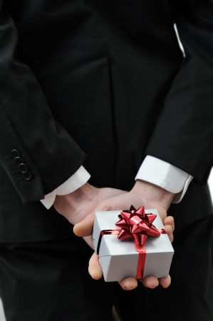 gift box in the hands of a elegant manの写真素材