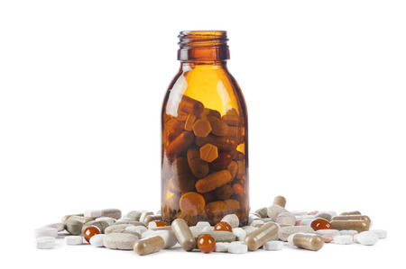 bottle with variety of pills and tablets on white backgroundの写真素材
