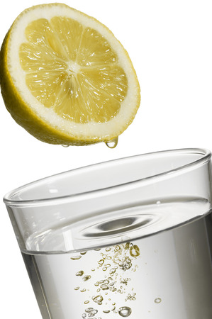 lemon drop on natural water glass, on white backgroundの写真素材