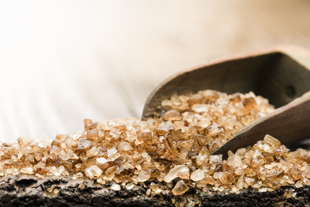 wooden scoop with smoked salt on tableの写真素材