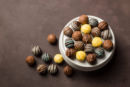 chocolates variety in white tray on brown background