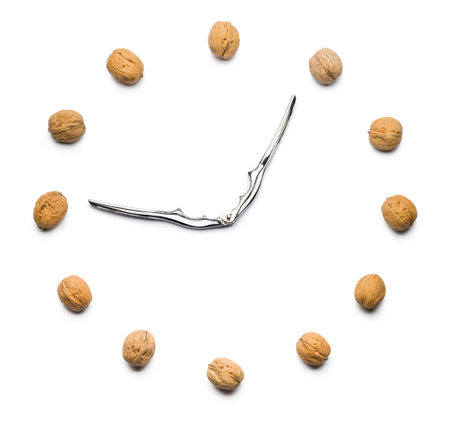walnuts clock with nutcracker as hands on white background
