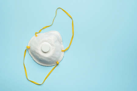 Antibacterial protective face mask with filter on blue backgroundの写真素材