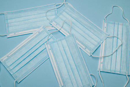 Surgical protective face mask on blue background