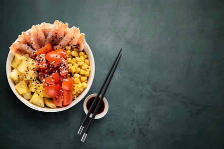 Top view of shrimps poke bowl with chopsticks and soy sauceの写真素材