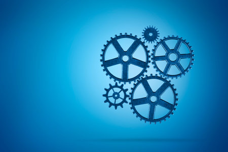 Metal gears on blue background. Teamwork business concept.