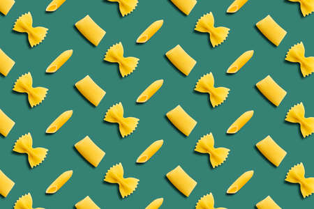 Italian pasta pattern on a green background. Top view.の写真素材