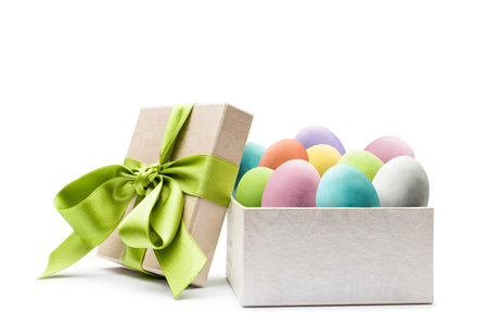 Colorful easter eggs into gift box, on white background