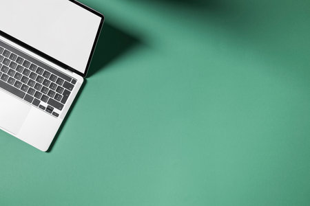 Laptop with blank screen on colored background, Top view with empty copy space.の写真素材