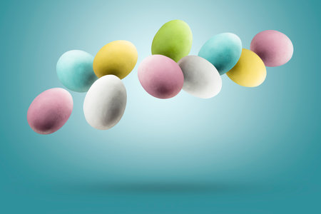 Colorful easter eggs floating on blue background.の写真素材