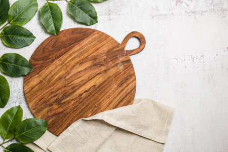 Wooden round cutting board top view on concrete background.の写真素材