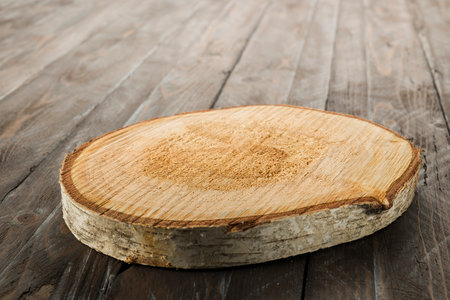 Wooden rustic cutting board on wooden table.の写真素材