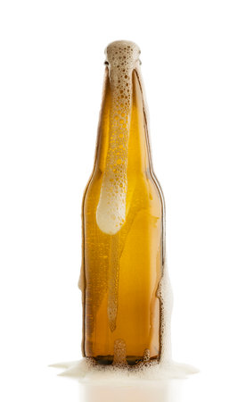 Bottle of blonde beer with foam out, isolated on white backgroundの写真素材