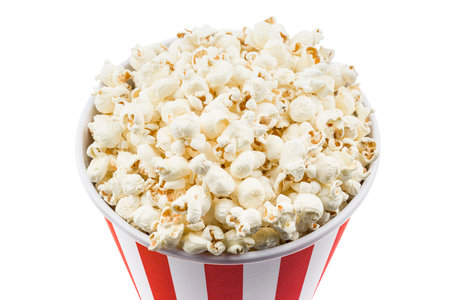 Popcorn close up in red and white striped container, isolated on white background.の写真素材