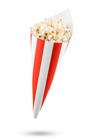 Popcorn in red and white striped paper cone, isolated on white background.の写真素材