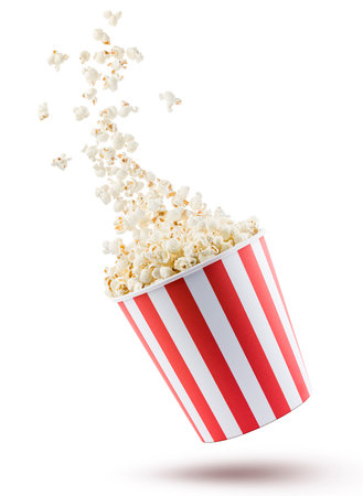 Popcorn flying from red and white striped container, isolated on white background.の写真素材