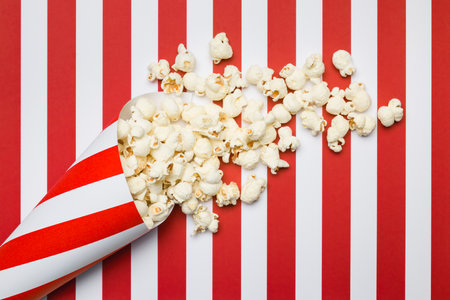 Flat lay composition with popcorn on red and white stripes background.の写真素材