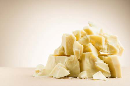 Pile of white chocolate flakes on cream colored background.の写真素材
