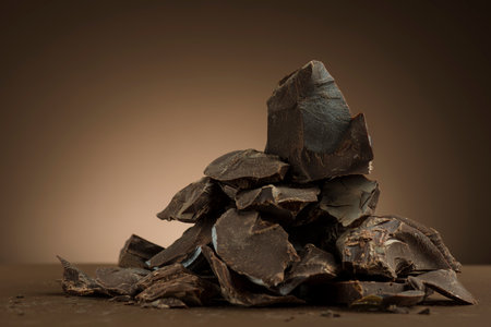 Pile of dark chocolate flakes on brown background.の写真素材