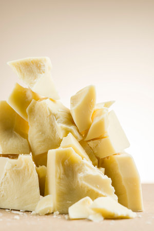 Pile of white chocolate flakes on cream colored background.の写真素材