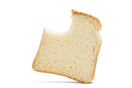Slices of white bread with bitten, isolated on white background.の写真素材