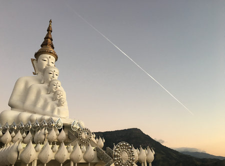 Prathat Phasornkaew temple with 5 white big buddha in the morning and sky fall, Phetchabun, Thailand