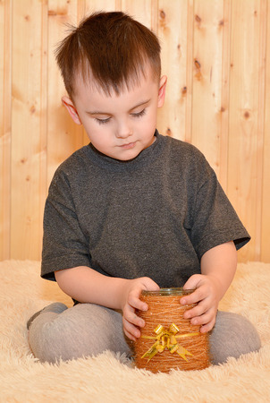 Serious little boy boy sittingの写真素材