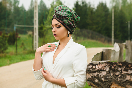 portrait of a girl with a scarf on her head in natureの写真素材