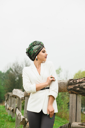 portrait of a girl with a scarf on her head in natureの写真素材