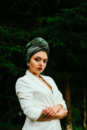 portrait of a girl with a scarf on her head in natureの写真素材