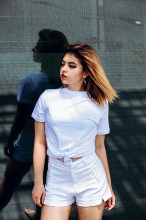 Stylish girl in white t-shirt and white shorts.