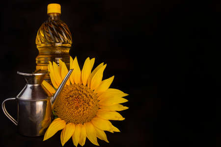 Sunflower and sunflower oil still life isolated on black backgroundの写真素材