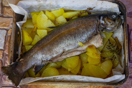 trout with potatoes in the oven cooked at home