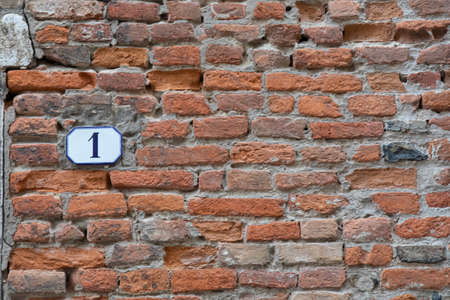 old brick wall with house number oneの写真素材