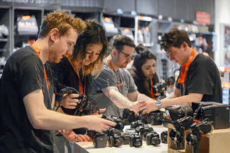 An engaging photograph of staff collaborating to set up a new camera display, capturing the teamwork involved in the wholesaling process. --ar 3:2 --v 6 Job ID: 1b953de7-5c60-4595-9040-353c826e3a45の素材
