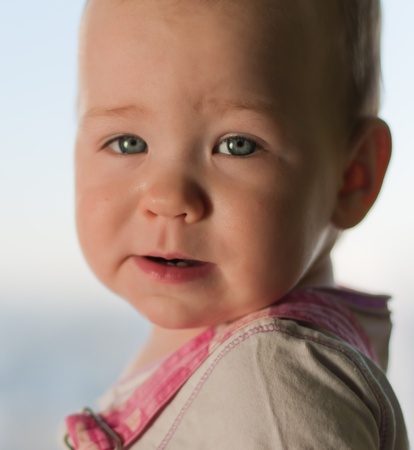 Little girl looks in cameraの写真素材