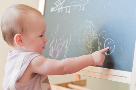 Little girl paints on the boardの写真素材